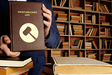 Jurist holding whistleblower law book