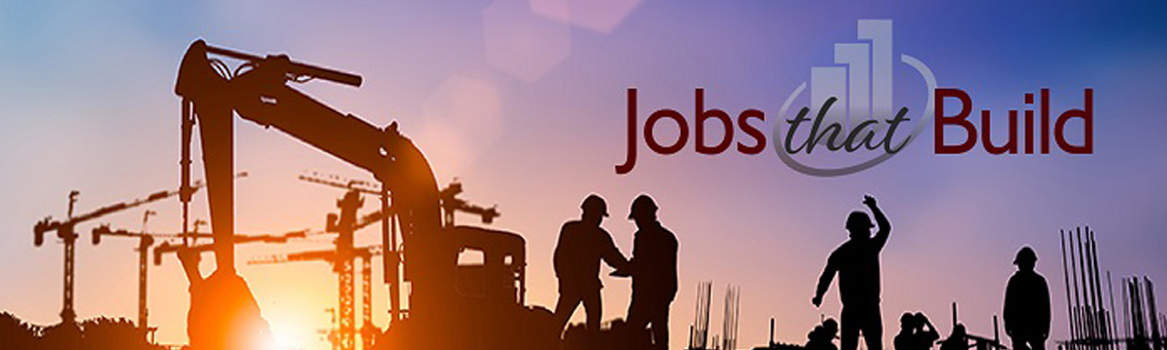 Image of a group of workers in hard hats working outside next to construction equipment 